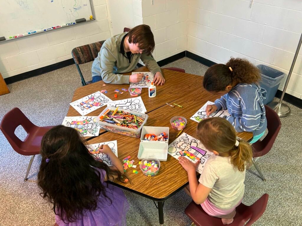 Children working on a craft at a table during Children's Church